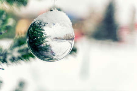 Christmas ball on spruce branches covered with snow. new year and christmas conceptの写真素材