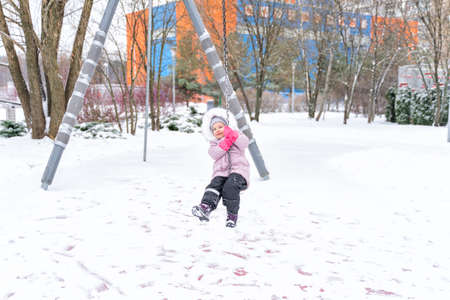 child walks in the park in winter.の写真素材