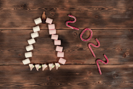 new year concept. text 2022 made from gummies. christmas tree from marshmallowsの写真素材