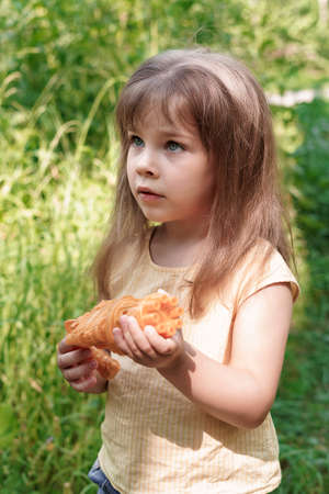 cute child girl with a toy gun on a summer dayの写真素材