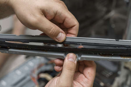 echnician or plumber repairing the dishwasher in a household. the rubber seal is damagedの写真素材