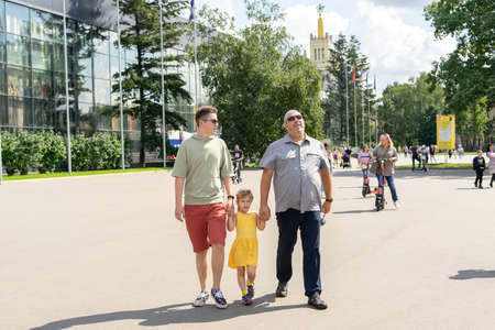 08.14.2021 Moscow, Russian Federation, family, dad and two children are walking along the alleys of VDNKhのeditorial素材