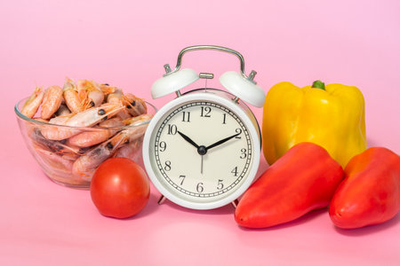 Alarm clock with vegetables and shrimp for weight lossの写真素材