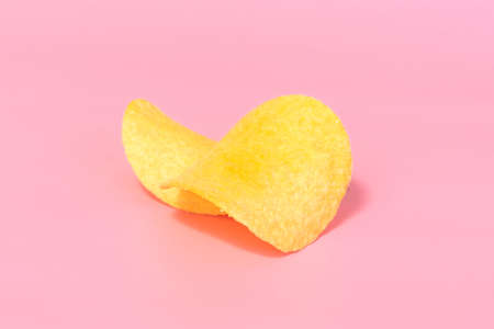 potato chips close-up on a pink backgroundの写真素材