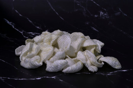 slices of potato chips close-up on a dark background.の写真素材