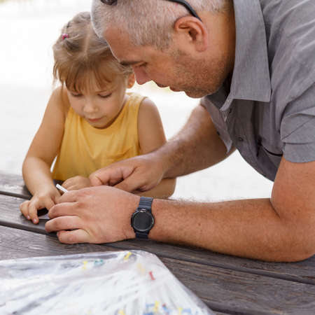 kid takes part in a master class for making paper craftsの写真素材