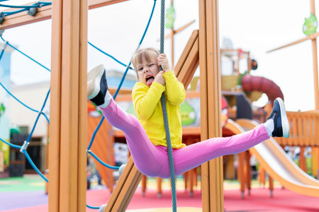 cute baby playing and climbing on the playground