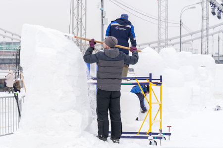 Moscow, Russia, 29.01.2022 a sculptor makes a giant snow figure at the Snow and Ice winter festival...