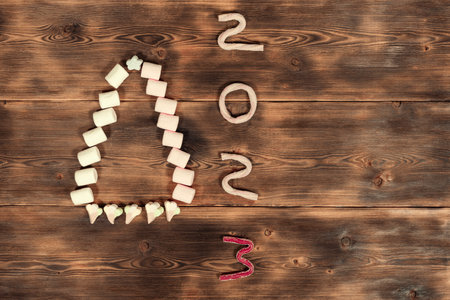 flat christmas composition of christmas tree made of marshmallows and text 2023 from jellyの写真素材
