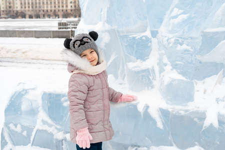portrait of a happy little girl on a winter snowy dayの写真素材