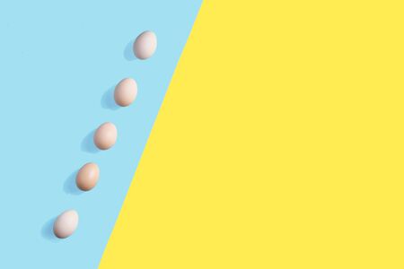 5 brown eggs on the flat background with geometric arragngmentの写真素材