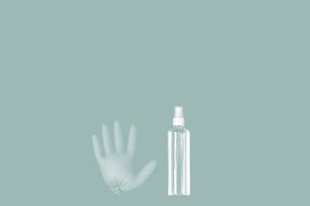 A medical glove and a a bottle of transparent sanitizer with outer placeの写真素材