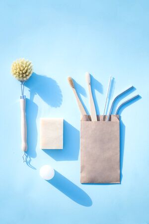 Brush soap deodarant and toothbrush with metallic straws on the blue backgroundの写真素材