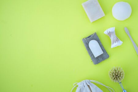 Eco product on the yellow background with wooden goods such toothe brush cotton budsの写真素材