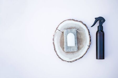 Sustainable products for bathroom on the background spray bottle, rock crystal deodorant, wooden plateの写真素材