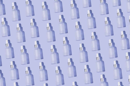 Dropper bottle pattern on the purple background minimal white cap and silver designの写真素材