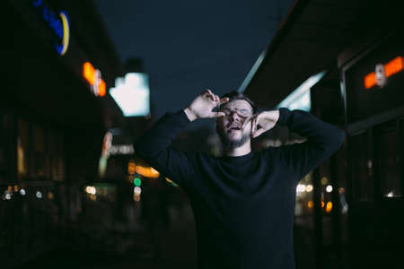Hipster with beard young man night photography glasses close upの写真素材
