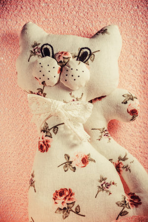 Self made soft toy. Handmade cat. Manual sewing white with pink flowers toy cat. A fun, soft toy...