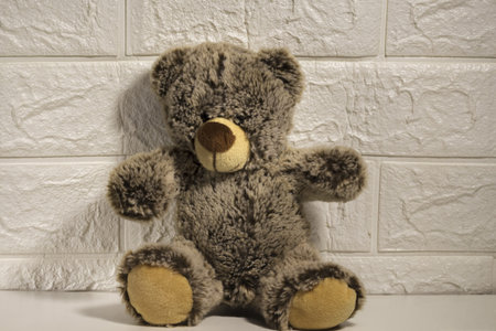 brown teddy bear sitting alone by the wall, goodbye childhood, abandoned toys,の写真素材