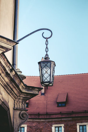 Old lantern, medieval street light in the street on the light background in Krakow. Poland
