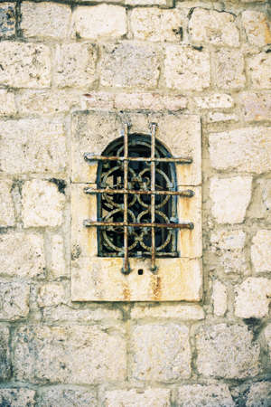 vintage lattice on the window, element of architecture of St.George Island in Perast on shore of Boka Kotor bay, Adriatic Sea, Montenegroの写真素材