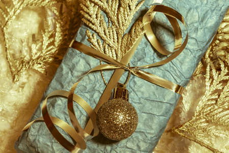Bronze New Year decorations and blue gift box. Top view. Christmas greeting card, natural colorsの写真素材
