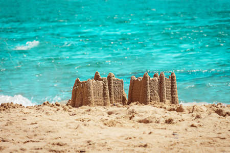 Sand castle with towers on the beach with view on the sea. Holiday concept with sand castle, Travel concept.の写真素材