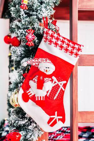 Christmas interior of room with decorated Red Christmas socks and Christmas tree, and wooden bed istylish interior of childrens room.の写真素材