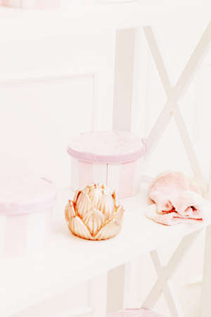 Home interior pastel, floral decor, gift, sweets, on white shelf . Sweet home.の写真素材