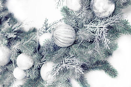 Christmas silver wreath decorations close up on light background.の写真素材