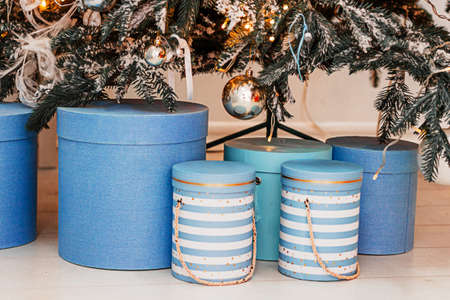 Close up of blue gift boxes Christmas presents under decorated treeの写真素材