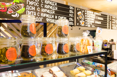 shop window cafe with pastries and leaf tea with price tags in Russianのeditorial素材