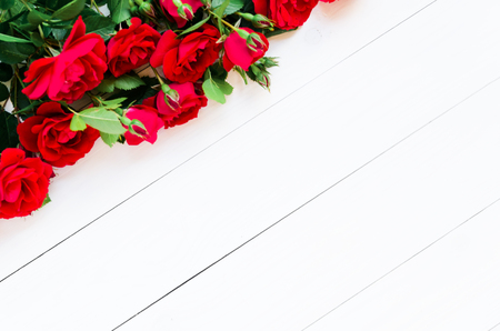 Home roses on a white wooden table flat lay. With copy spaceの写真素材