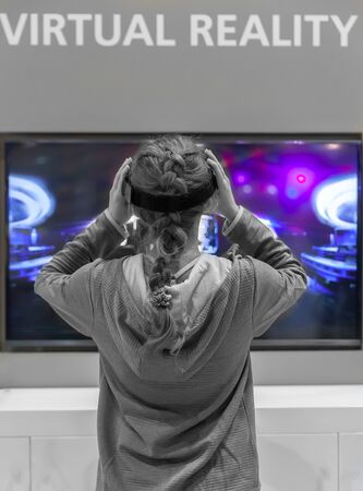 Young Cocausian Woman using Virtual Reality headsetの写真素材