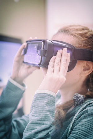Young Cocausian Woman using Virtual Reality headset