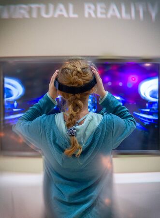 Young Cocausian Woman using Virtual Reality headsetの写真素材