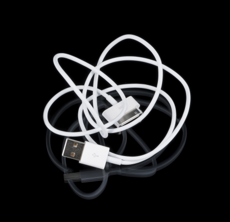 White cable with connectors on black backgroundsの写真素材
