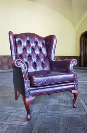 Old vintage red leather chair in the interiorの写真素材