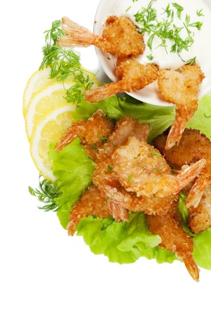 Fried prawns in coconut breading with dipping sauce and dill on white isolated backgroundの写真素材