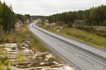 Highway among granite rocks in early autumn   Autumn landscape の写真素材