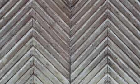 Old wooden gate with pig-iron rivets as a backgroundの写真素材