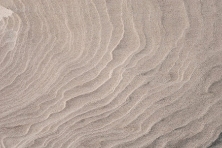 Closeup of sand pattern of a beach in the summer