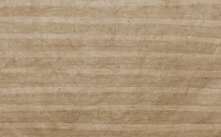Texture of handmade striped rumpled paper sheet  of color of sepia as backgroundの写真素材