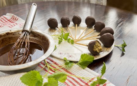 Healthy raw mint candies on sticks in raw chocolate with mint on old vintage table.の写真素材