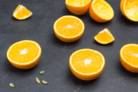 Orange sliced on table. Black background. Top view.