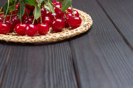 Bunch of cherries on table. Wooden background. Top view. Copy spaceの写真素材
