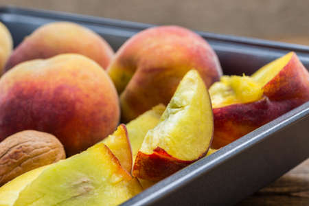 Ripe peaches in metal tray. Close up. Top viewの写真素材