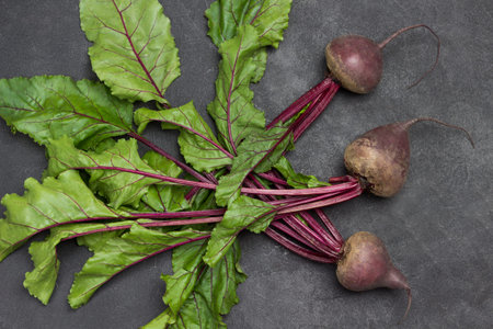 Beets with tops on table. Flat lay. Black background