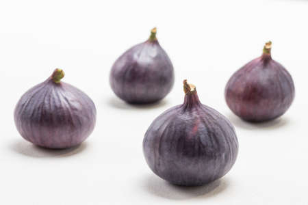 Whole purple figs. White background. Top viewの写真素材