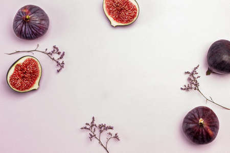 Purple figs on pink. Copy space. Food background. Flat layの写真素材